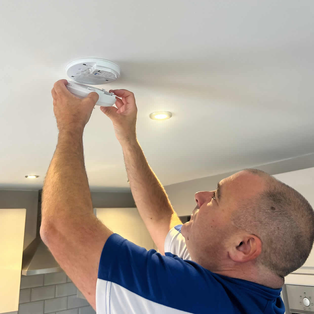 Smoke alarm being installed on a ceiling in Oldbury